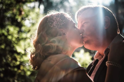 bride and groom on the background of trees and forest sun.