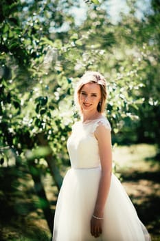beautiful young bride in the garden background.
