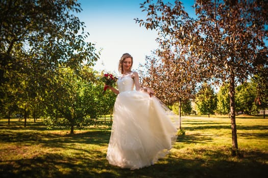happy young bride on autumn forest background.