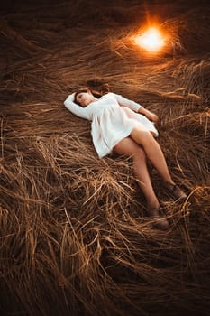 girl lying on the field on a sunset background.