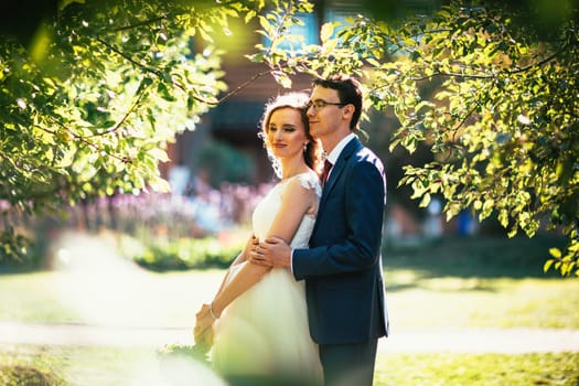 bride and groom on background summer forest.