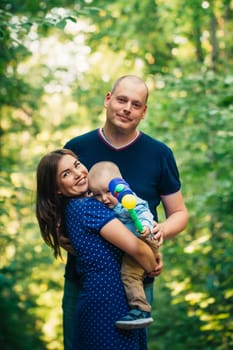 happy family with son on background forest