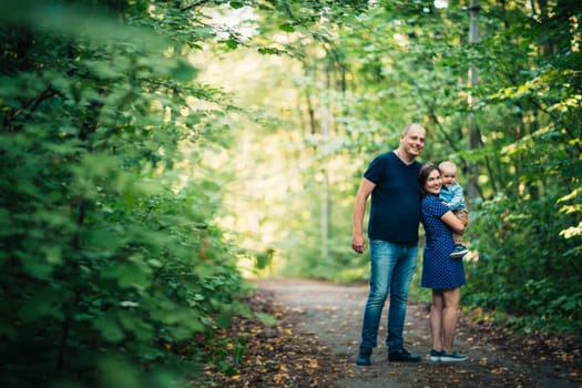 happy family with son on background forest
