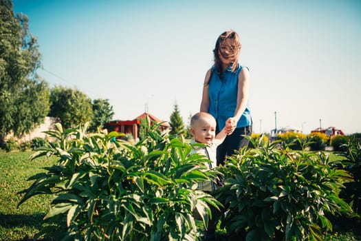 happy mother and toddler son on nature background.