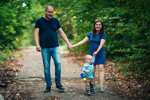 happy family with son on background forest