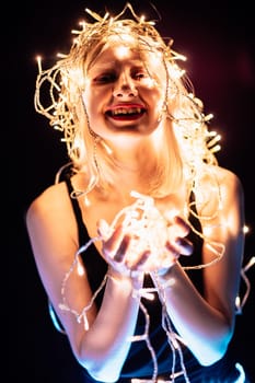 portrait of a girl with a garland on black background.