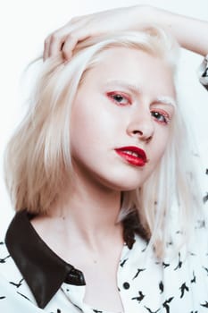 portrait blonde albino girl in studio on white background.
