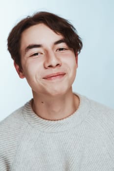 portrait of a teenager brunette guy in a studio.