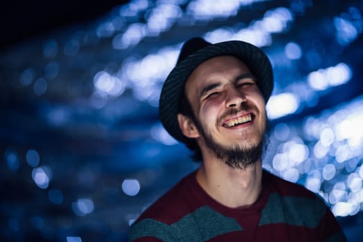 portrait of a guy in a hat on a blurred background.