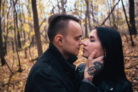 portrait of a young woman and a man walking in the autumn forest.