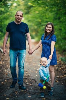 happy family with son on background forest