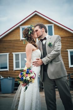 bride and groom in the background of the house.