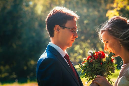 bride and groom on background summer forest.