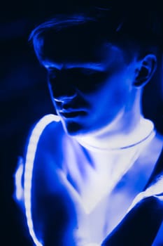Portrait man Strip Light LED tape on dark color background.
