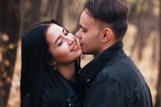 portrait of a young woman and a man walking in the autumn forest.