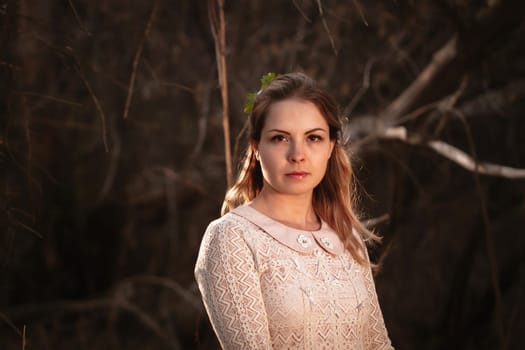 portrait of a girl in a field on a sunset background.
