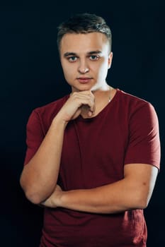 portrait of a young man on a dark background.