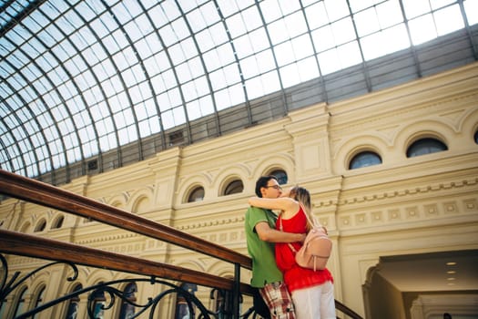 girl and guy stand on the background of the bridge