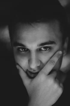 black white photo portrait of a young man on a blurred background.