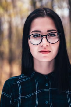 portrait of a young woman in the autumn forest.