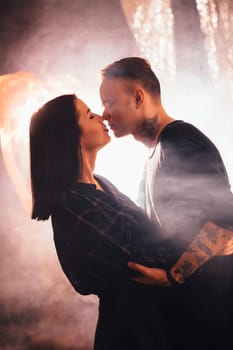 Couple in fashionable clothes on a shiny background.