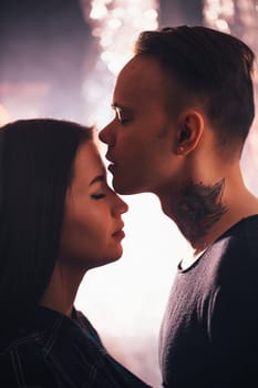 guy and the girl kiss closeup on a light background