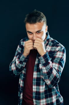 portrait of a young man on a dark background.