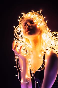 portrait of a girl with a garland on black background.