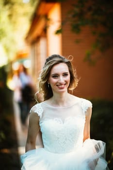Beautiful young bride on blurred background.
