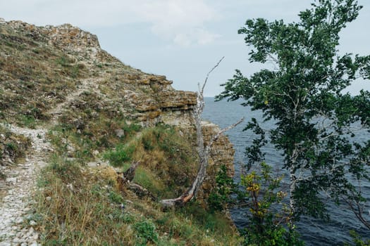 landscape river cliff grass on the sky background.