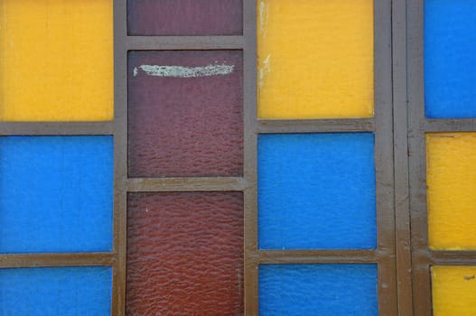 Colorful stained glass abstract squares on church window.