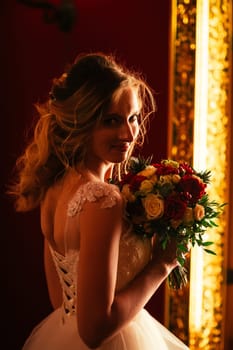 Portrait young beauty bride near the window.
