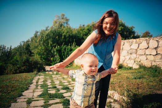 happy mother and toddler son on nature background.