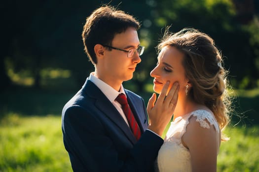 bride and groom embracing on nature background.
