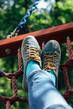 boots on a hammock against the backdrop of nature.