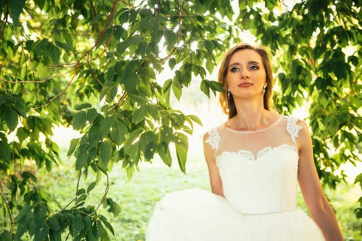 beautiful young bride in the garden background.