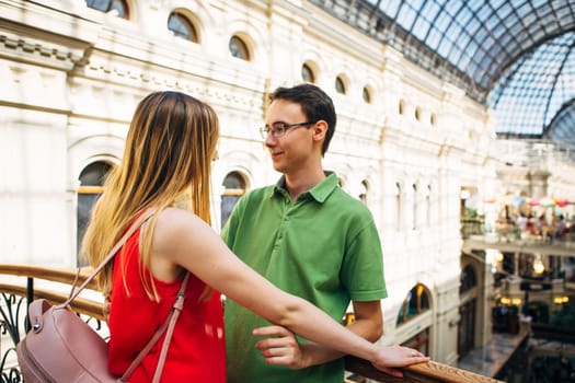 girl and guy stand on the background of the bridge