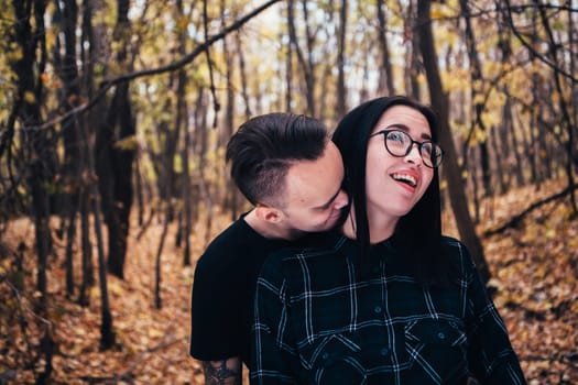 man and woman in the autumn forest