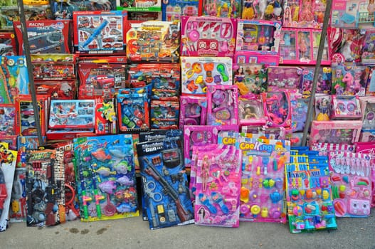 ATHENS, GREECE - AUGUST 15, 2014: Toys for girls and boys for sale at street market.