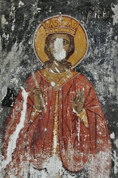 ATHENS, GREECE - SEPTEMBER 2, 2014: Weathered wall painting of saint holy figure byzantine era religious art. Church of the Holy Apostles Solaki, Ancient Agora.