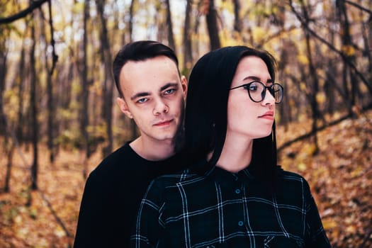 man and woman in the autumn forest