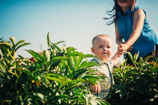 happy mother and toddler son on nature background.