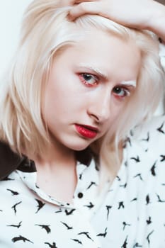 portrait blonde albino girl in studio on white background.