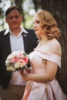 bride and groom kiss on the background of trees and forest.