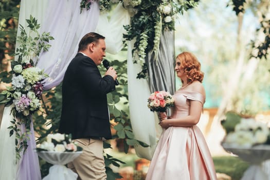 bride and groom on wedding ceremony on background nature.