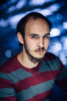 portrait of a guy in a hat on a blurred background.