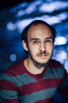 portrait of a guy in a hat on a blurred background.