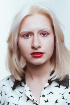portrait blonde albino girl in studio on white background.