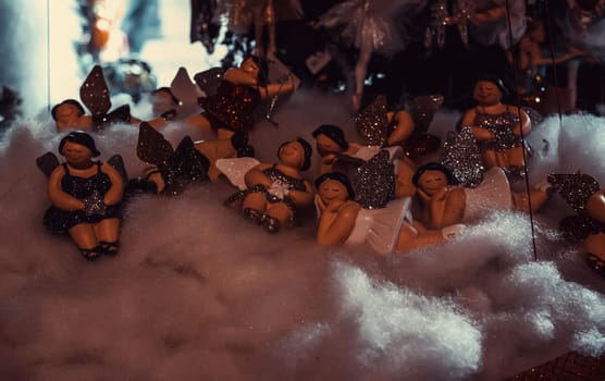 Christmas angels in decoration shop, showcase at parties
