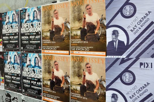 ATHENS, GREECE - OCTOBER 15, 2014: Wall plastered with live music concert posters indie rock by Morrissey and dj sets of minimal techno by Ray Okpara and psychedelic trance by Infected Mushroom.